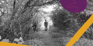 Woman walking into the forest.