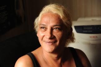 Portrait of Brisa Escobar. She has blonde hair, pulled back in a pony tail and the day light is illuminating her face on the right-hand side. 